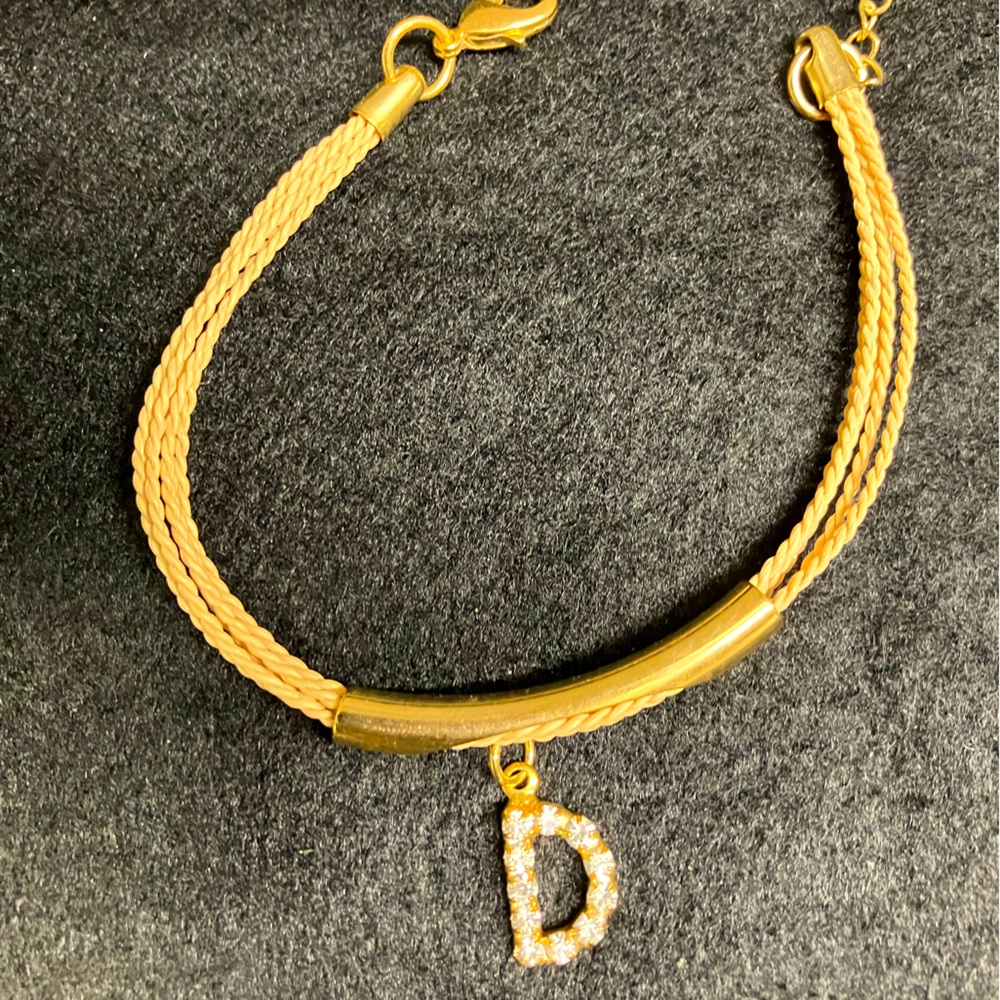 Initial gold and native reed bracelet from Brazil